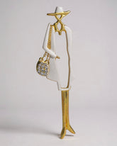 Vintage Lady Brooch – Glossy gold-tone with a white enamel hat and hand muff. A graceful nod to vintage elegance